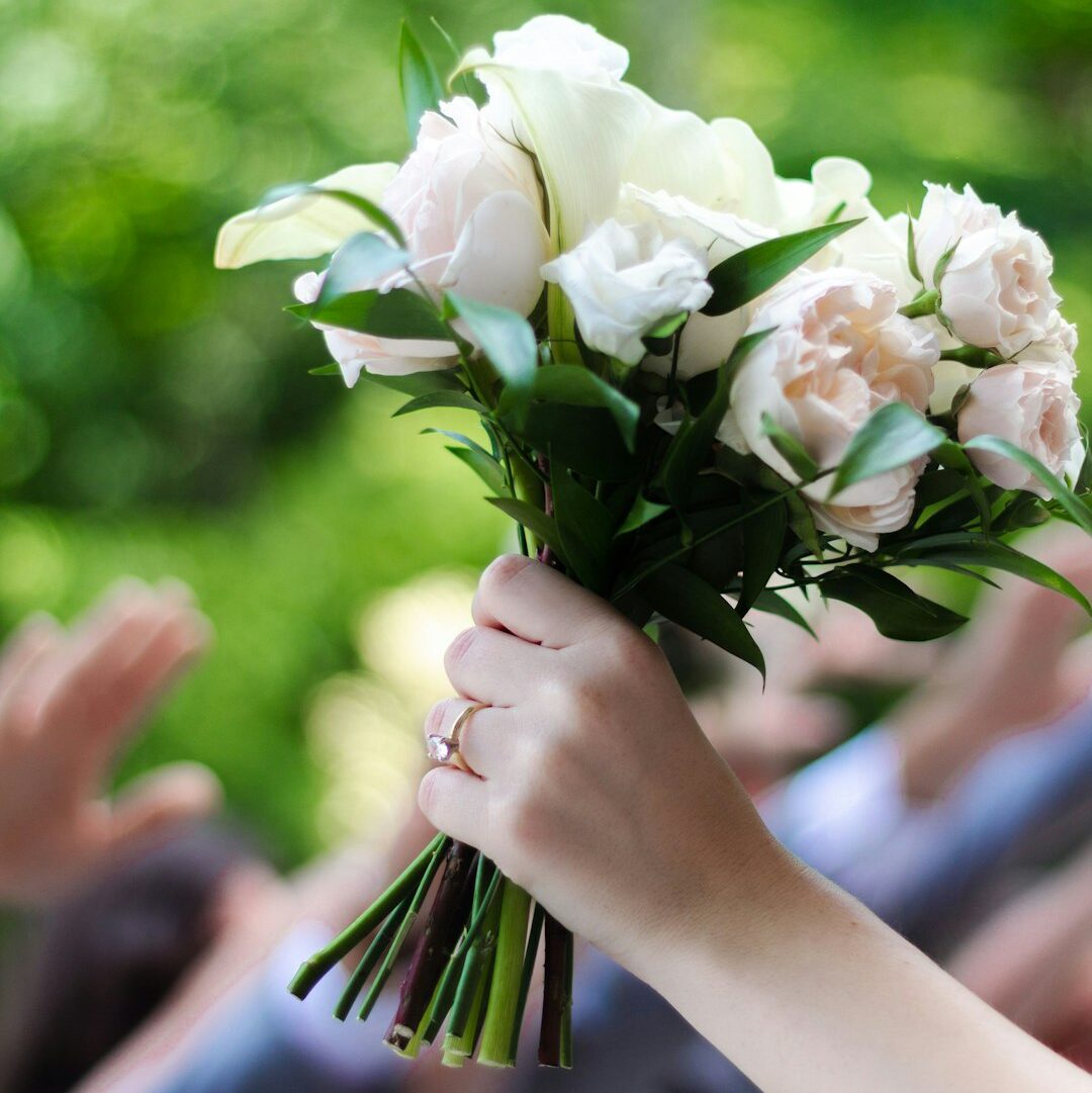 a-group-of-hands-holding-white-flowers-ab5gmdd-1k0